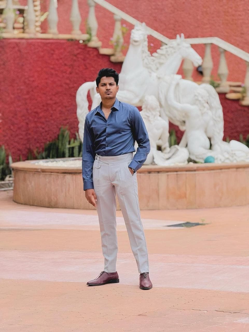 Abhijeet Raskar, standing in front of a sculpture